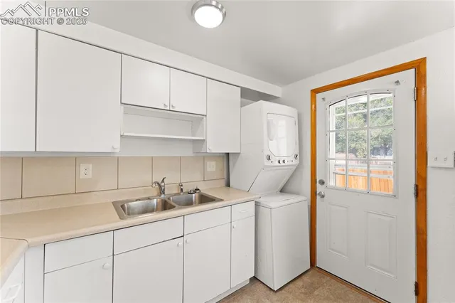 a kitchen with cabinets a sink and appliances