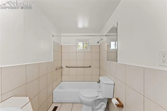 a bathroom with a toilet and shower