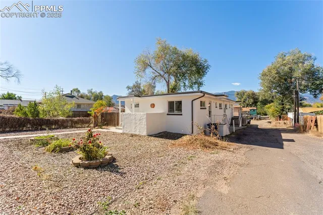 a view of a house with a yard covered in snow