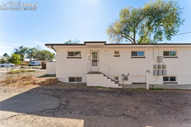 a view of a backyard with large trees