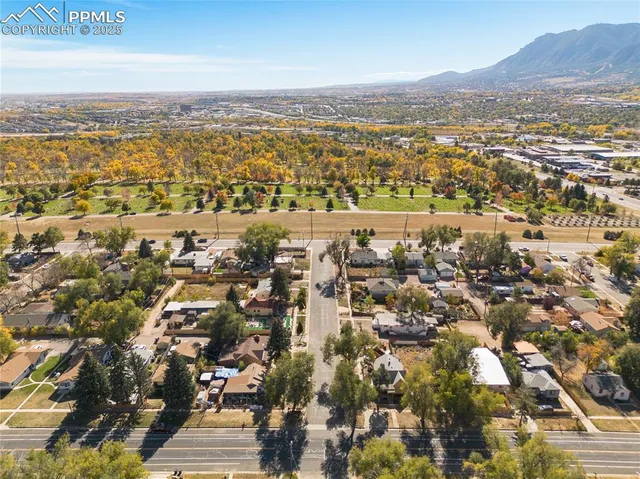 an aerial view of residential building with parking and yard