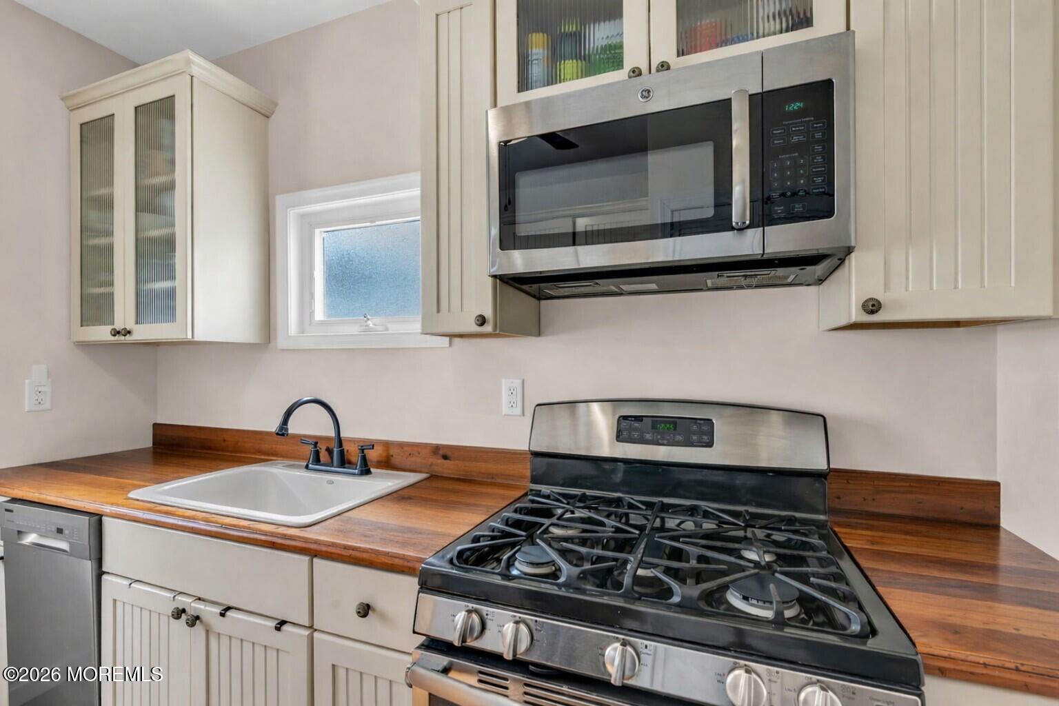6 Beach Street Sea Bright, NJ 07760 - Photo 11 of 31 a kitchen with stainless steel appliances granite countertop a stove and a microwave