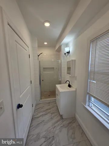 a bathroom with a bathtub and shower