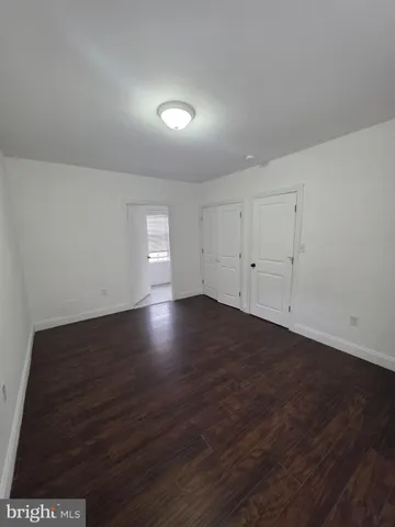 a view of wooden floor and windows in a room