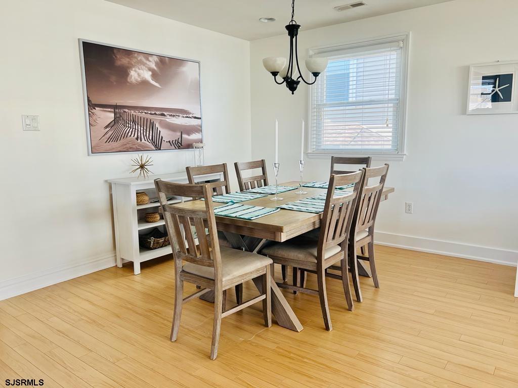 4 North Decatur Avenue Margate City, NJ 08402 - Photo 11 of 28 a view of a dining room with furniture wooden floor and a chandelier