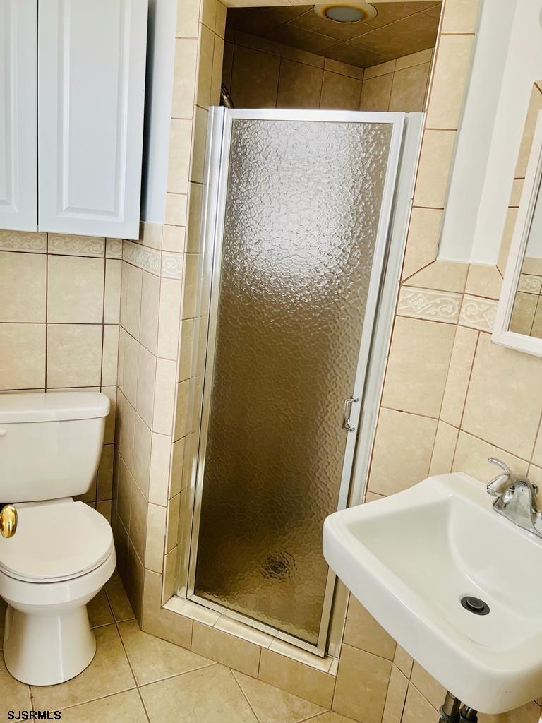 4 North Decatur Avenue Margate City, NJ 08402 - Photo 15 of 28 a bathroom with a sink a toilet and shower