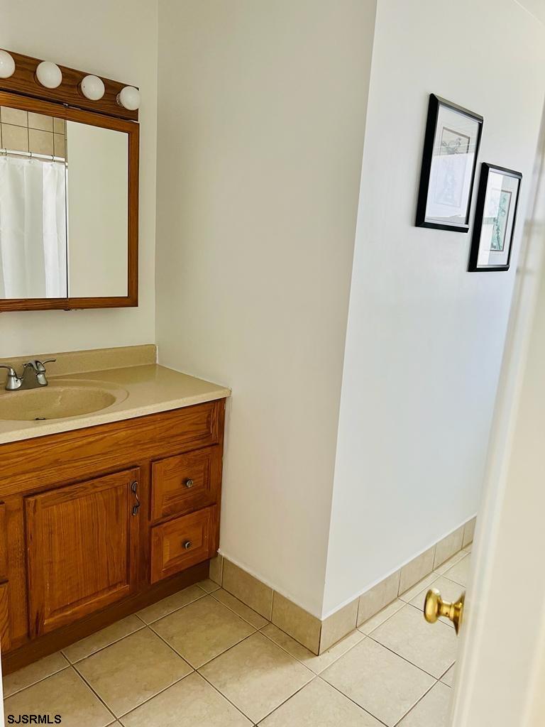 4 North Decatur Avenue Margate City, NJ 08402 - Photo 16 of 28 a bathroom with a sink a mirror and vanity