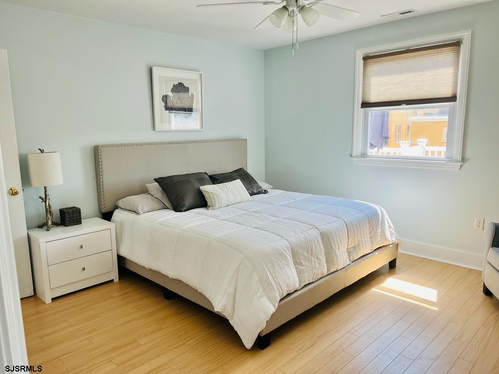 4 North Decatur Avenue Margate City, NJ 08402 - Photo 17 of 28 a bedroom with a bed and a painting on the wall