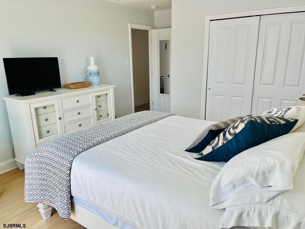 4 North Decatur Avenue Margate City, NJ 08402 - Photo 18 of 28 a bedroom with a bed and flat screen tv