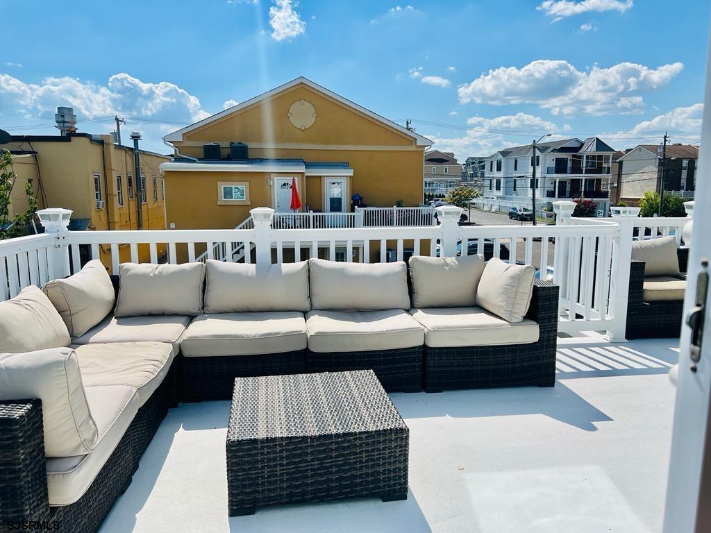 4 North Decatur Avenue Margate City, NJ 08402 - Photo 27 of 28 a living room with furniture a chandelier and a rug