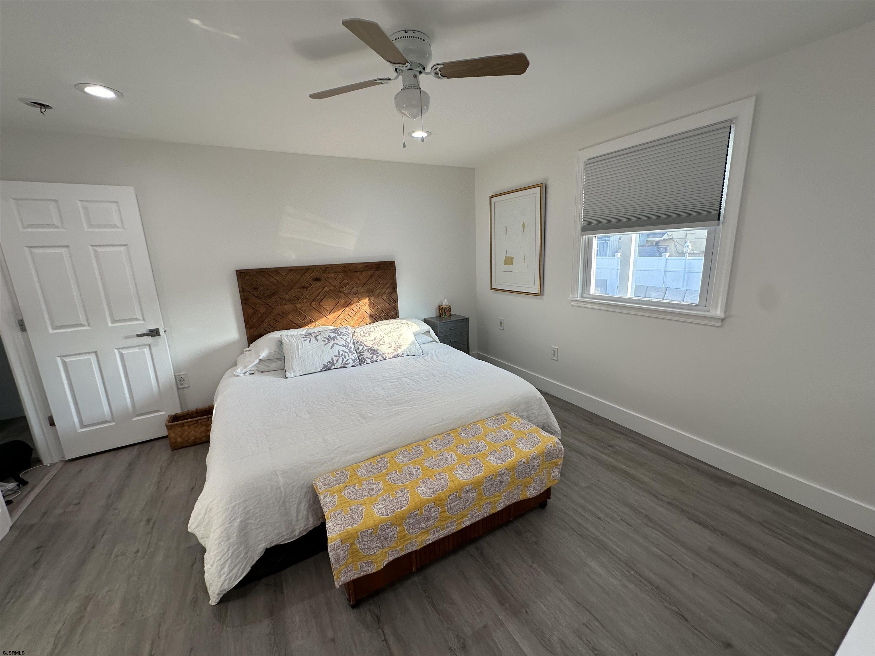 4 North Decatur Avenue Margate City, NJ 08402 - Photo 5 of 28 a bed sitting in a bedroom next to a window