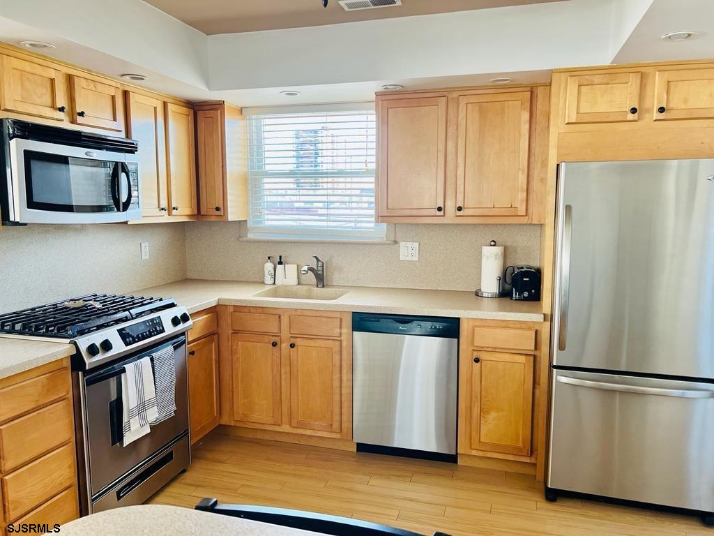 4 North Decatur Avenue Margate City, NJ 08402 - Photo 8 of 28 a kitchen with granite countertop a refrigerator stove top oven and sink