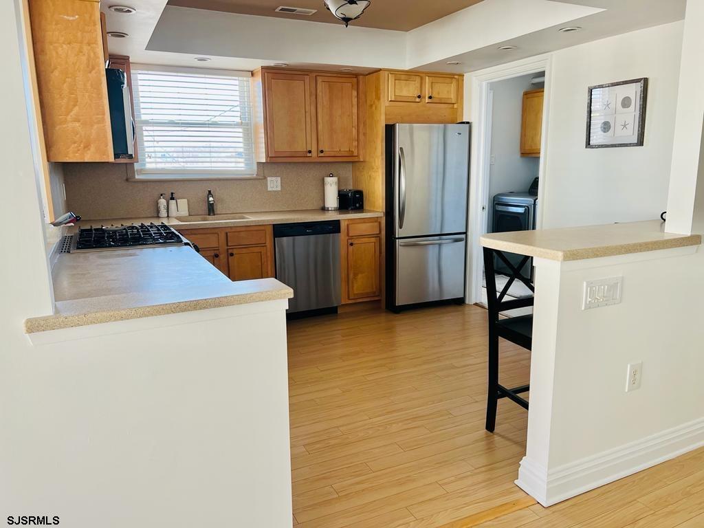 4 North Decatur Avenue Margate City, NJ 08402 - Photo 9 of 28 a kitchen with a refrigerator sink and stove
