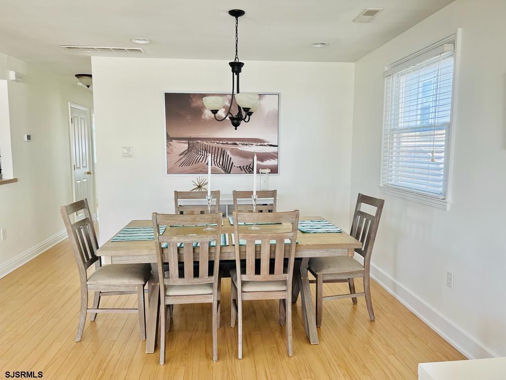 4 North Decatur Avenue Margate City, NJ 08402 - Photo 10 of 28 a view of a dining room with furniture wooden floor and chandelier