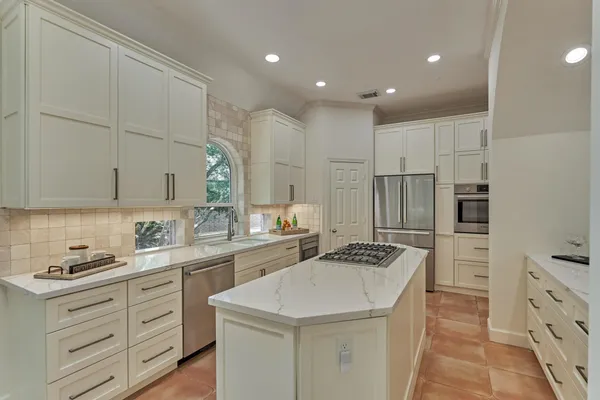 a kitchen with a sink stove and refrigerator