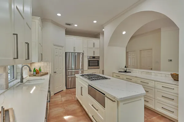 a kitchen with a sink stove and refrigerator