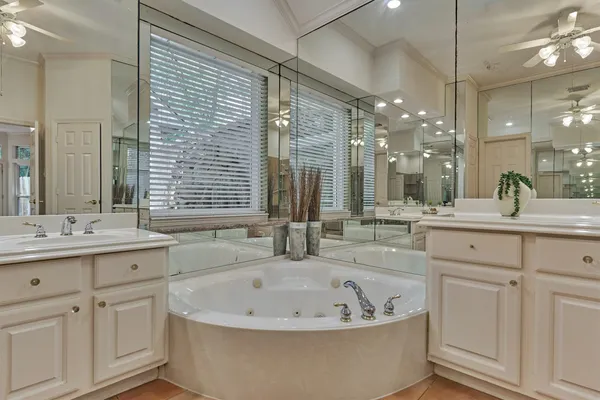 a bathroom with a bathtub and double sink