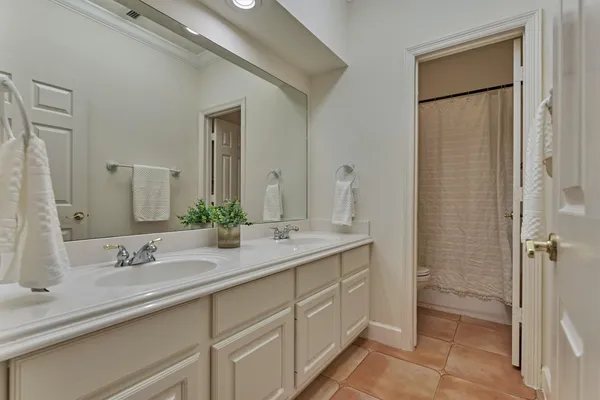 a bathroom with a double vanity sink and mirror