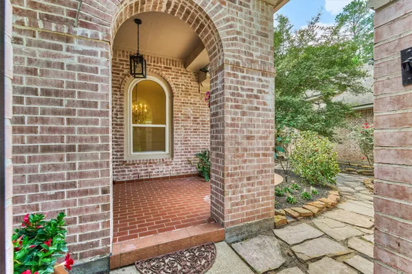 a front view of a house with plants