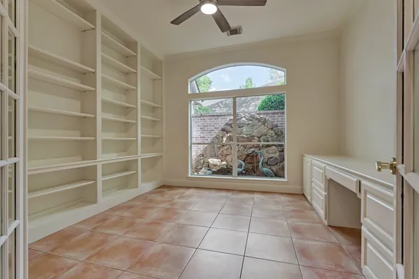 a view of an empty room with a fireplace and a window