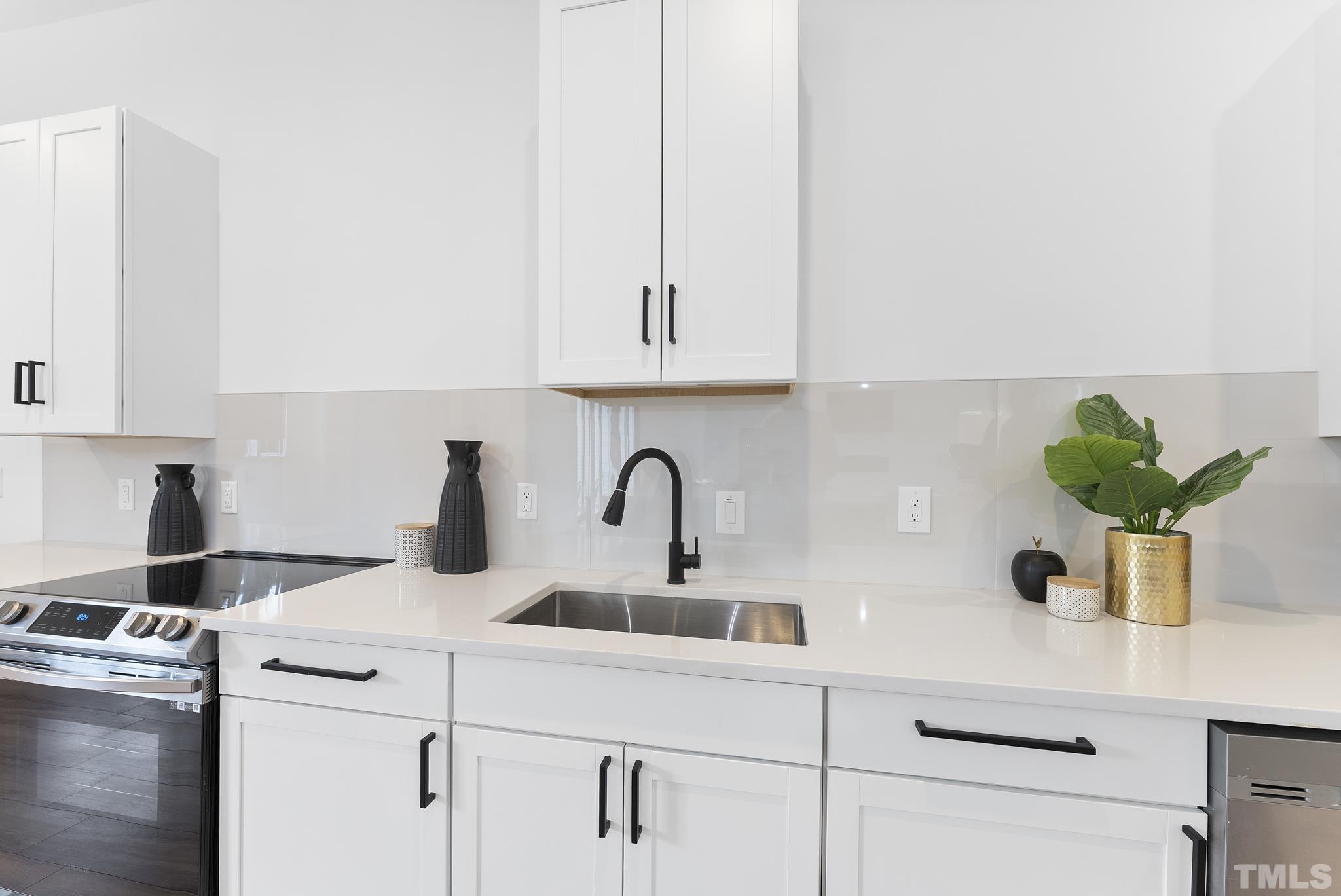 1920 Cook Road Durham, NC 27713 - Photo 13 of 43 a kitchen with appliances a sink and cabinets
