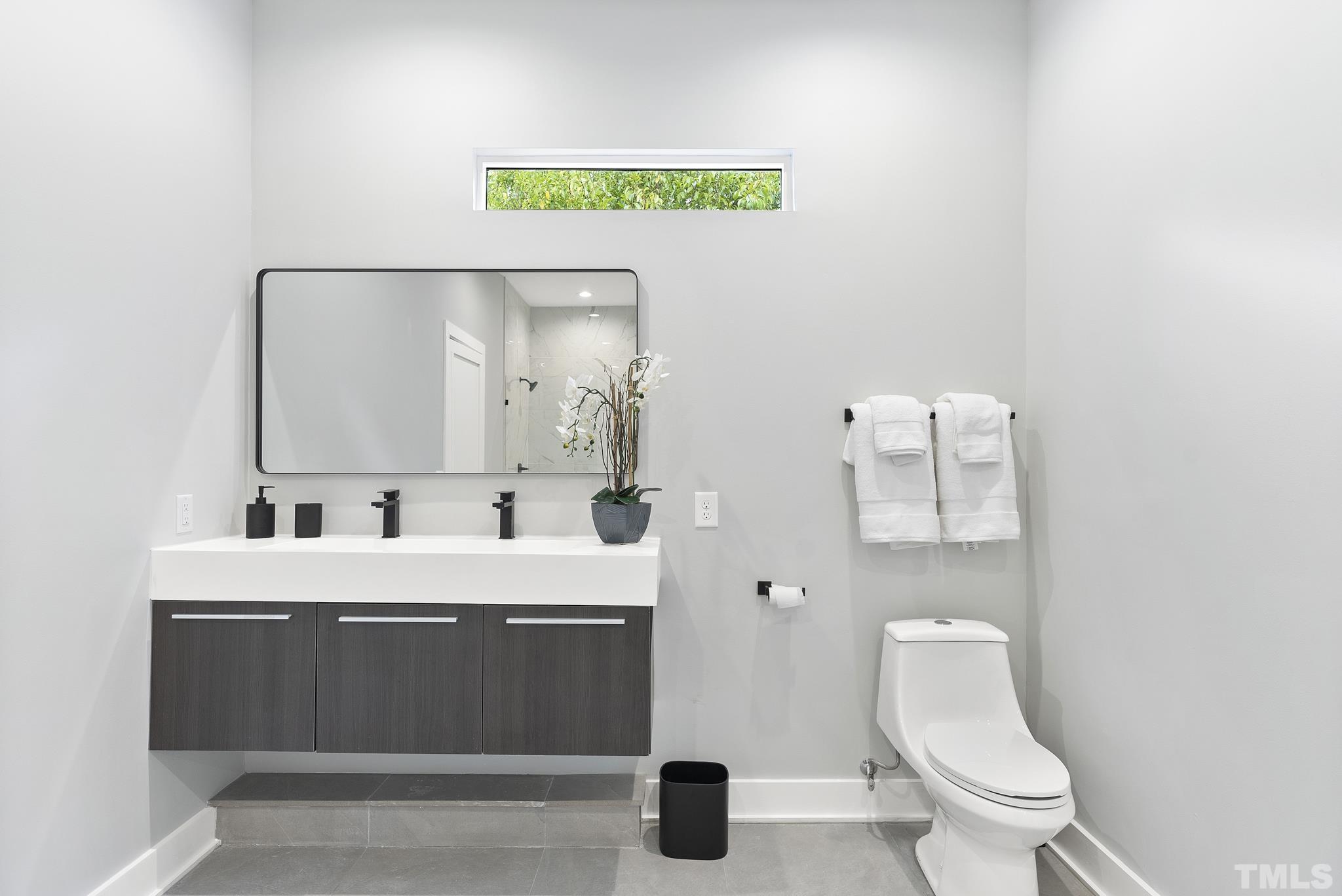 1920 Cook Road Durham, NC 27713 - Photo 21 of 43 a bathroom with a sink mirror and toilet