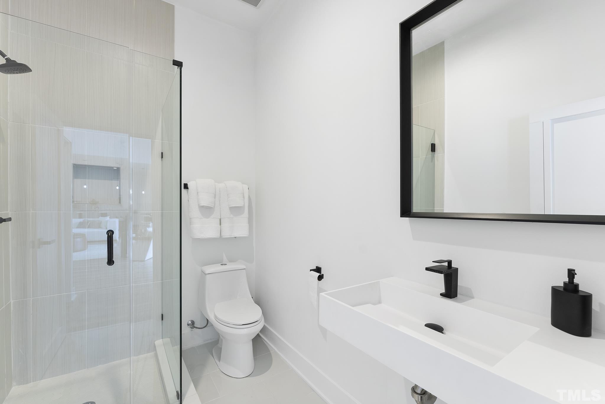 1920 Cook Road Durham, NC 27713 - Photo 30 of 43 a bathroom with a sink a toilet and shower