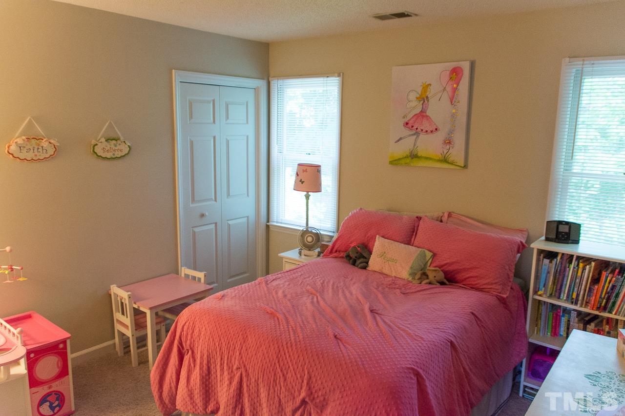 3452 Singleleaf Lane Raleigh, NC 27616 - Photo 14 of 22 a bedroom with a bed and a book shelf