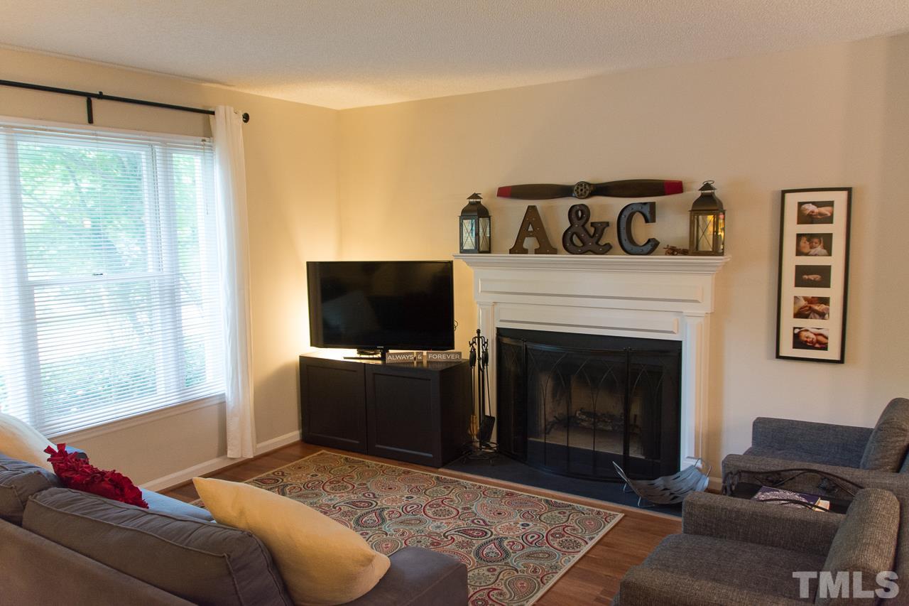 3452 Singleleaf Lane Raleigh, NC 27616 - Photo 3 of 22 a living room with furniture and a fireplace