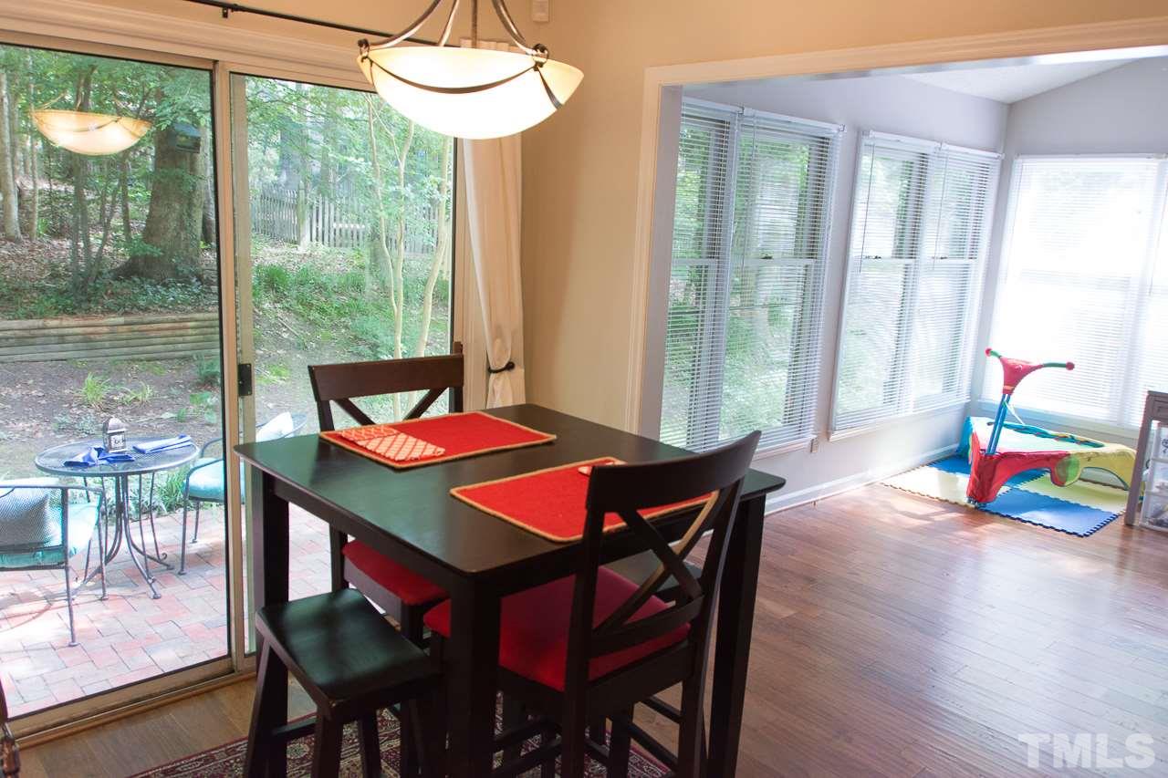 3452 Singleleaf Lane Raleigh, NC 27616 - Photo 8 of 22 a dining room with furniture and a floor to ceiling window