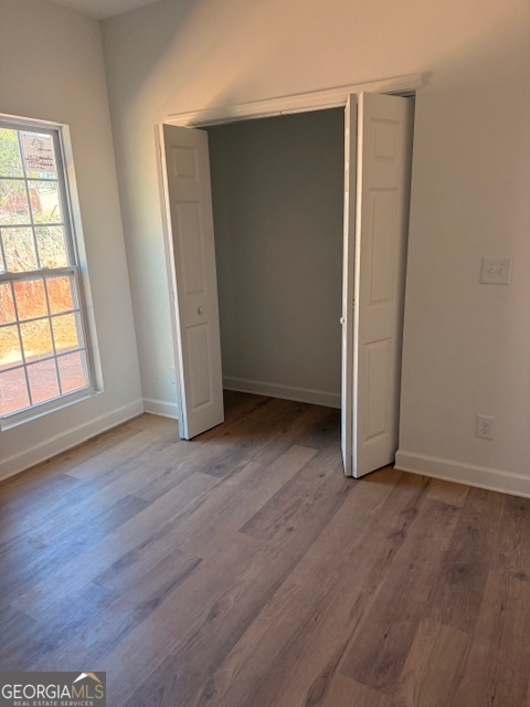 285 Madison Road Monticello, GA 31064 - Photo 12 of 15 an empty room with wooden floor and windows