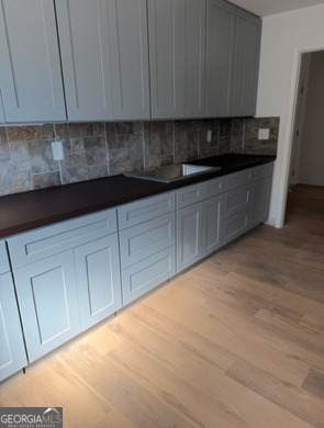 285 Madison Road Monticello, GA 31064 - Photo 9 of 15 a kitchen with granite countertop white cabinets and stainless steel appliances
