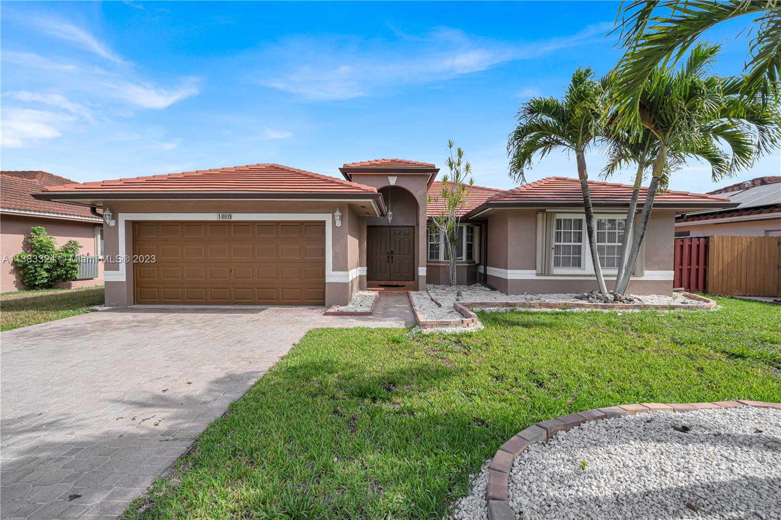14809 Southwest 180th Street Miami, FL 33187 - Photo 1 of 38 front view of a house with a yard