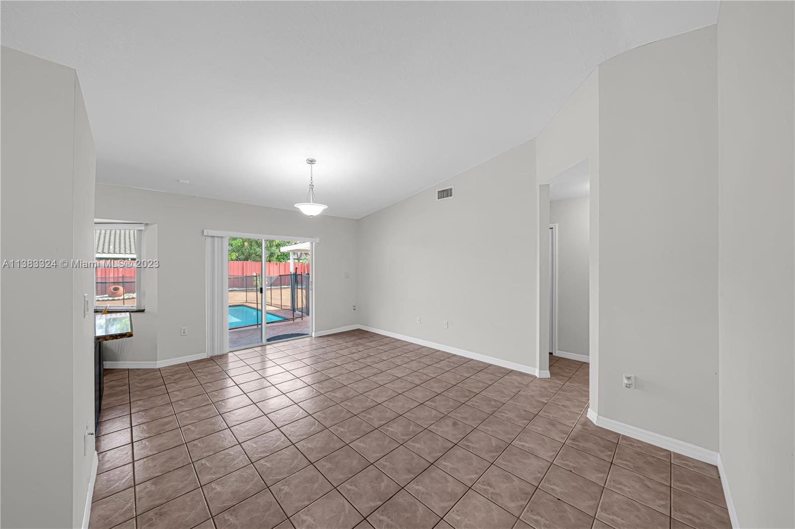 14809 Southwest 180th Street Miami, FL 33187 - Photo 11 of 38 a view of an empty room with a window