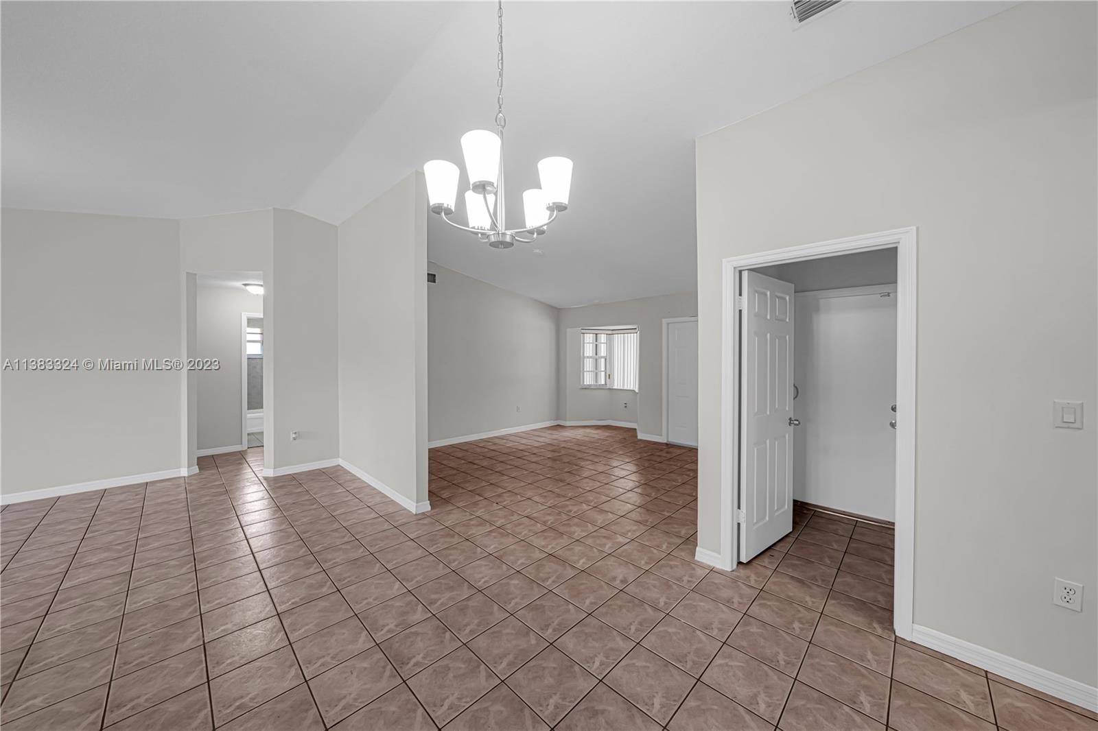 14809 Southwest 180th Street Miami, FL 33187 - Photo 17 of 38 a view of a chandelier fan and entryway