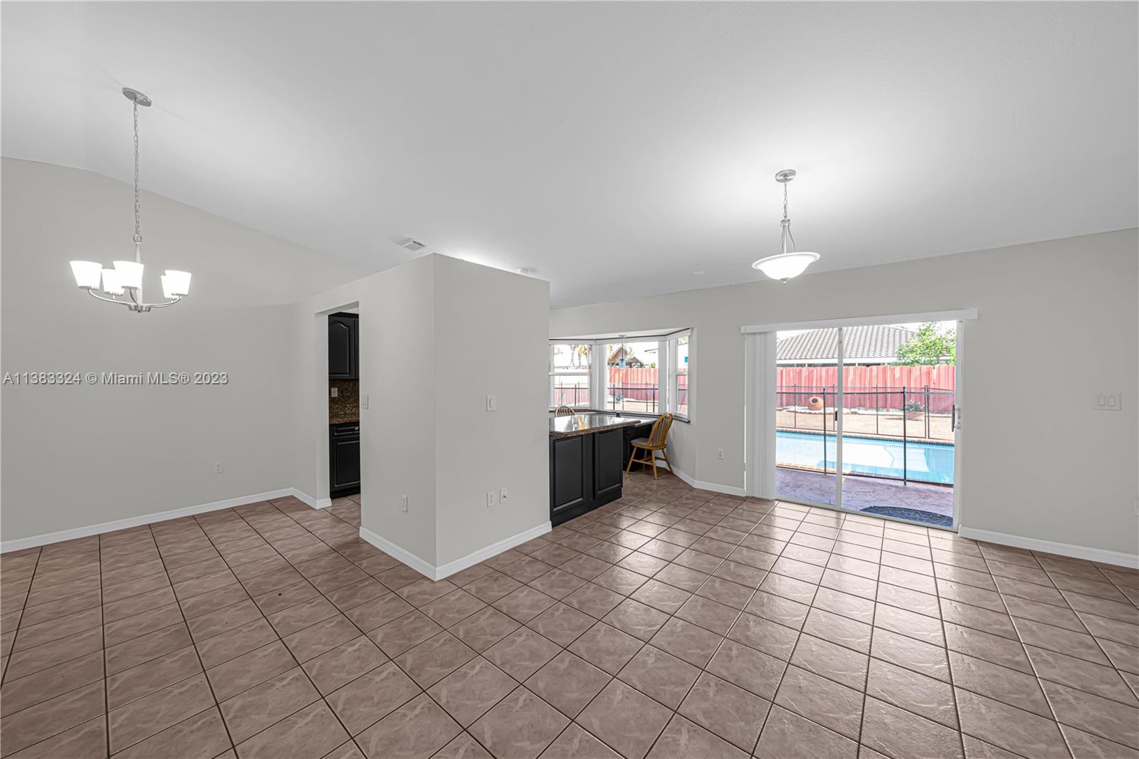 14809 Southwest 180th Street Miami, FL 33187 - Photo 19 of 38 a view of a room with window and chandelier