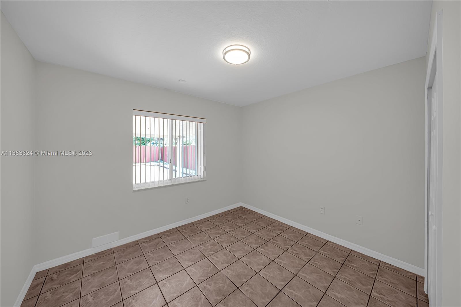 14809 Southwest 180th Street Miami, FL 33187 - Photo 21 of 38 an empty room with windows