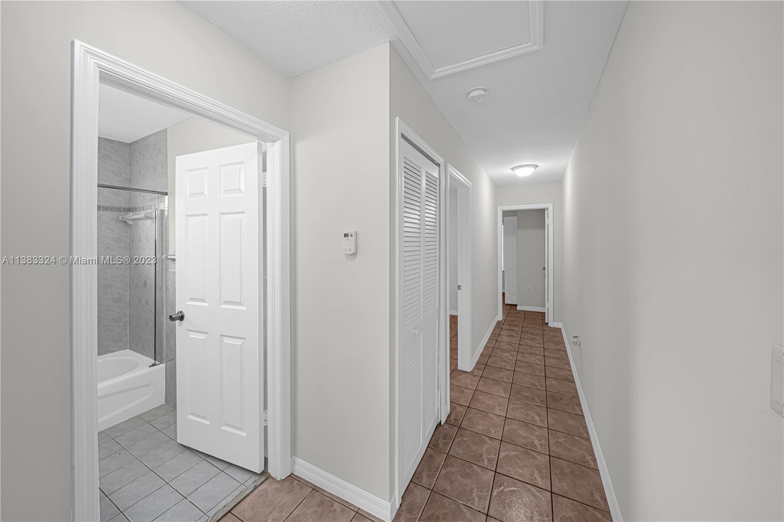 14809 Southwest 180th Street Miami, FL 33187 - Photo 22 of 38 a view of a hallway with white walls
