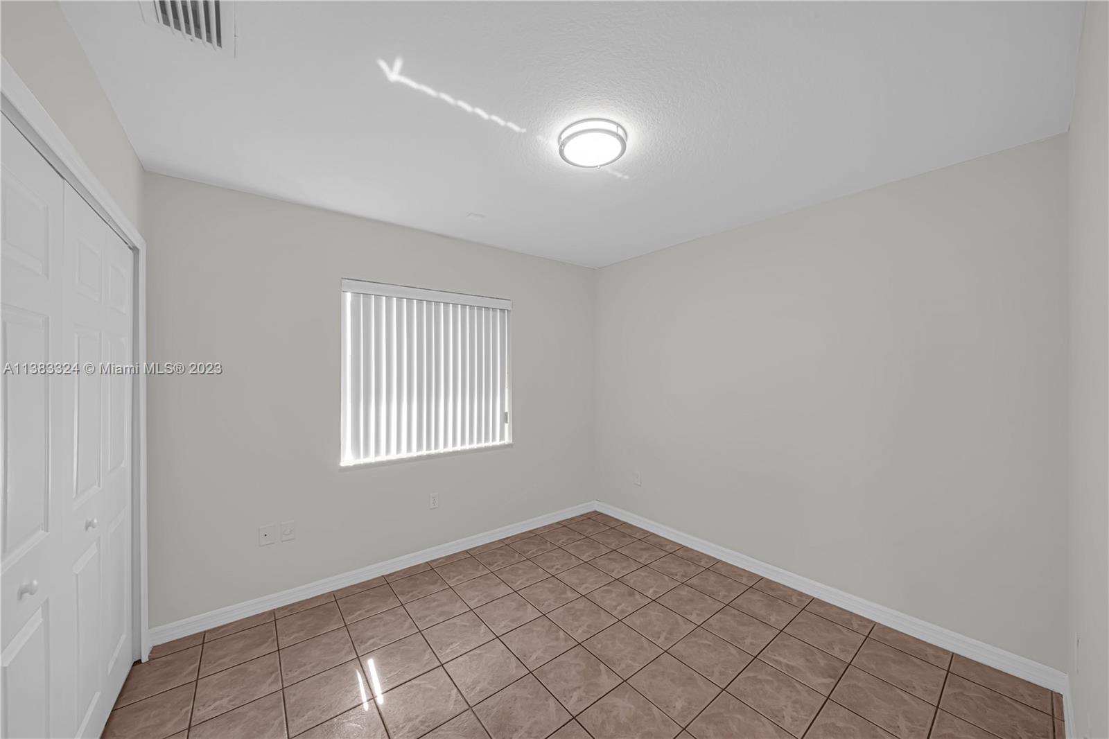 14809 Southwest 180th Street Miami, FL 33187 - Photo 23 of 38 an empty room with windows