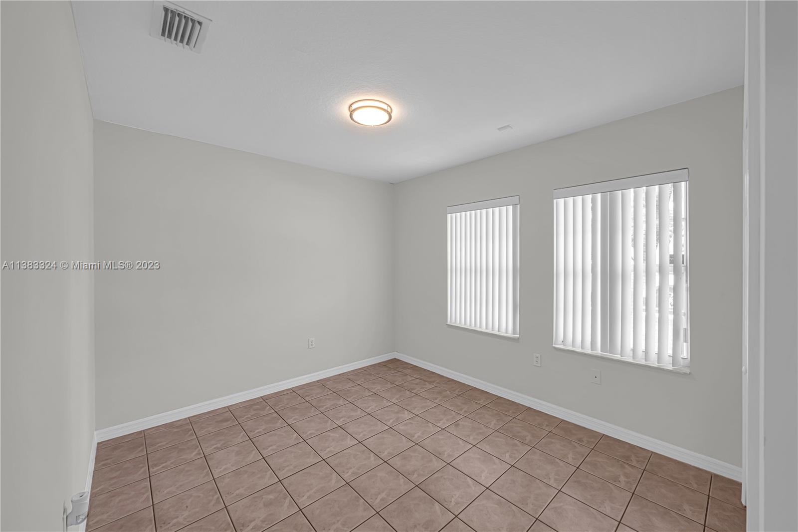 14809 Southwest 180th Street Miami, FL 33187 - Photo 24 of 38 an empty room with windows