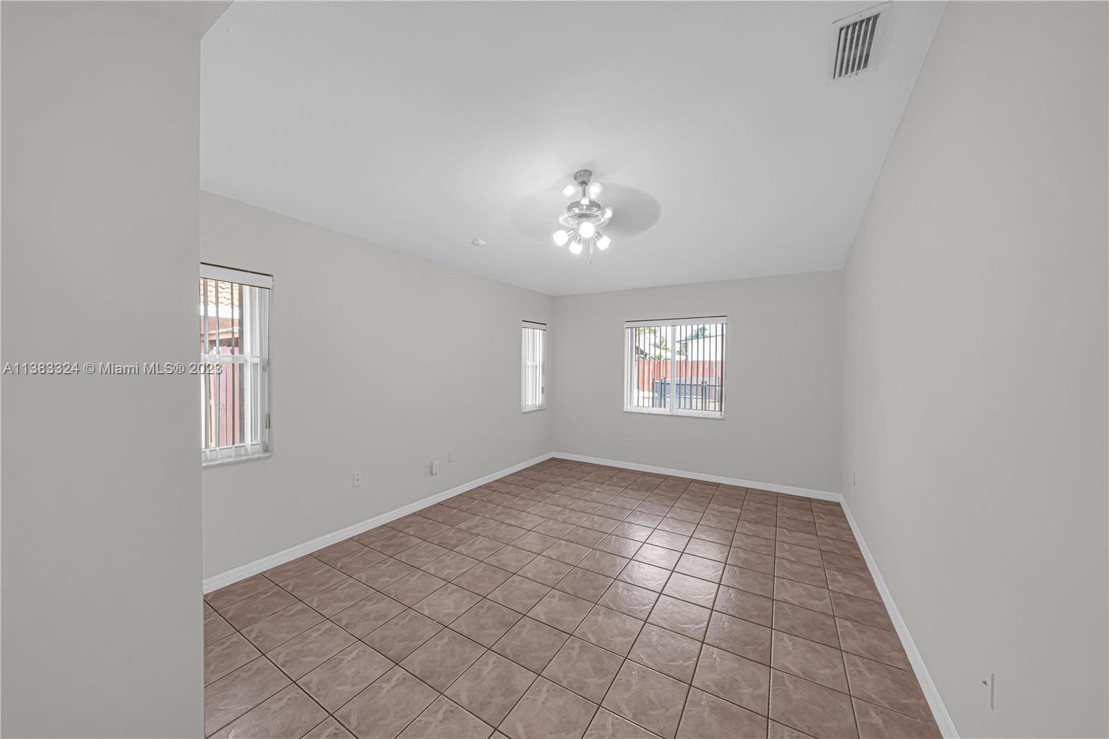 14809 Southwest 180th Street Miami, FL 33187 - Photo 25 of 38 a view of an empty room with a window