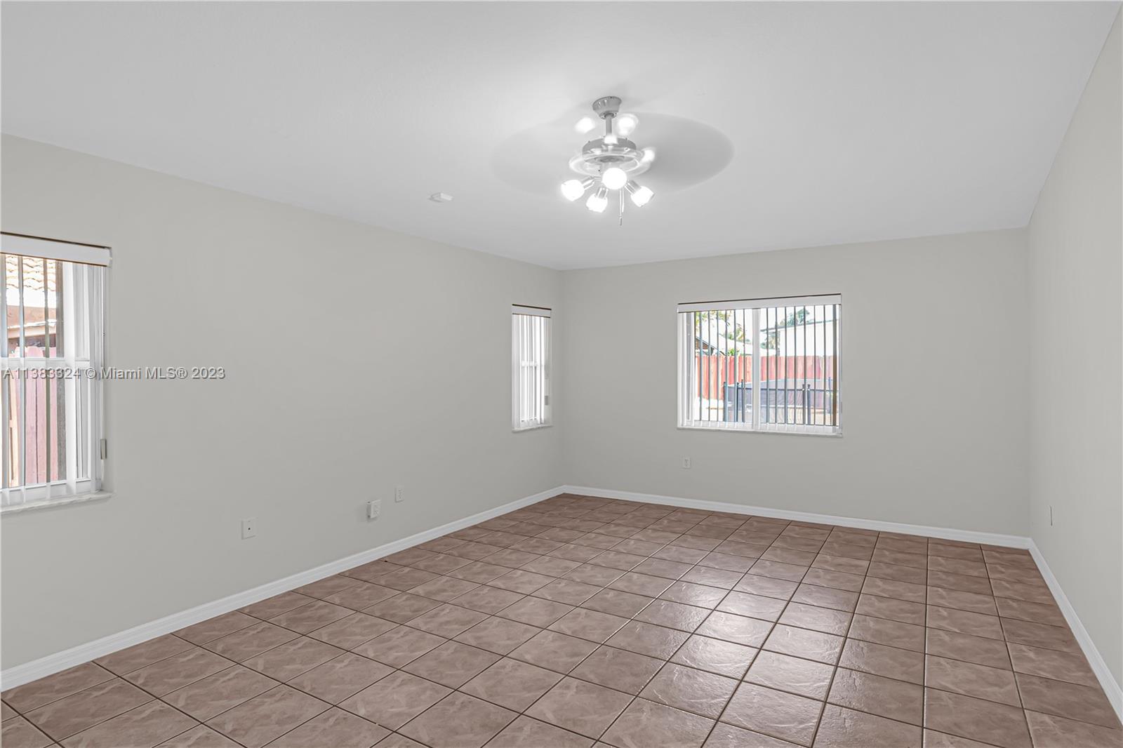 14809 Southwest 180th Street Miami, FL 33187 - Photo 26 of 38 a view of an empty room with a window