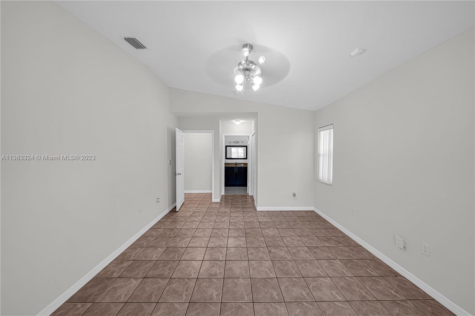 14809 Southwest 180th Street Miami, FL 33187 - Photo 27 of 38 a view of an empty room with a bathroom