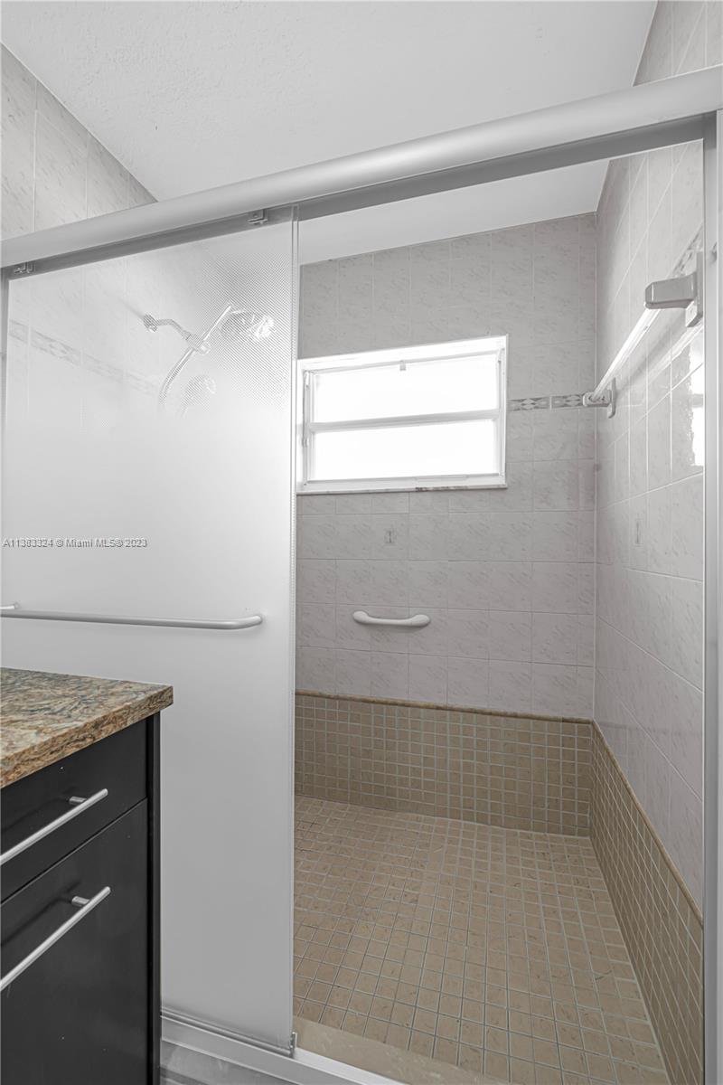 14809 Southwest 180th Street Miami, FL 33187 - Photo 30 of 38 a bathroom with a bathtub