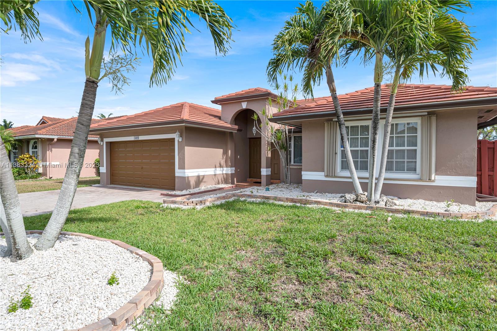 14809 Southwest 180th Street Miami, FL 33187 - Photo 5 of 38 a front view of a house with garden