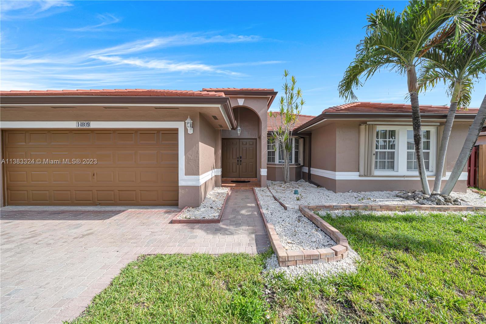 14809 Southwest 180th Street Miami, FL 33187 - Photo 6 of 38 a front view of a house with garden
