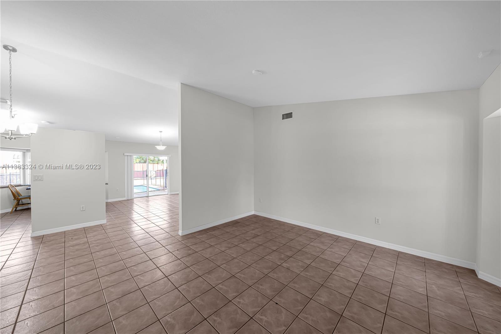 14809 Southwest 180th Street Miami, FL 33187 - Photo 9 of 38 a view of a hallway with wooden floor