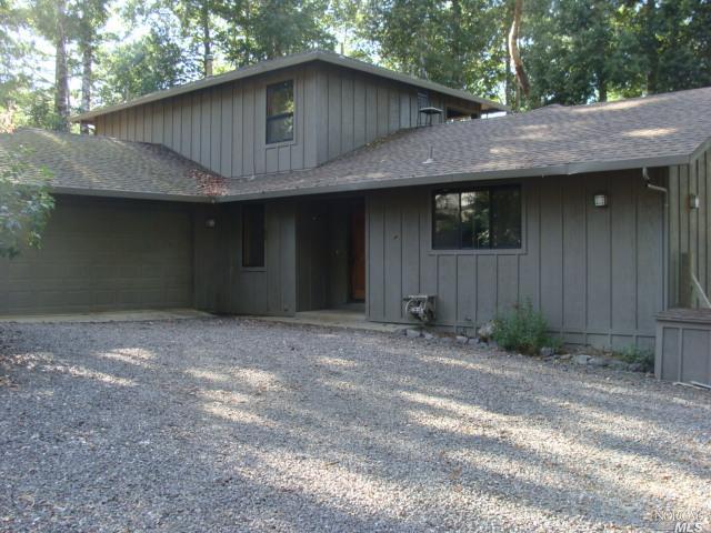 29740 Timberline Road Willits, CA 95490 - Photo 1 of 1 a backyard of a house with large trees and wooden fence