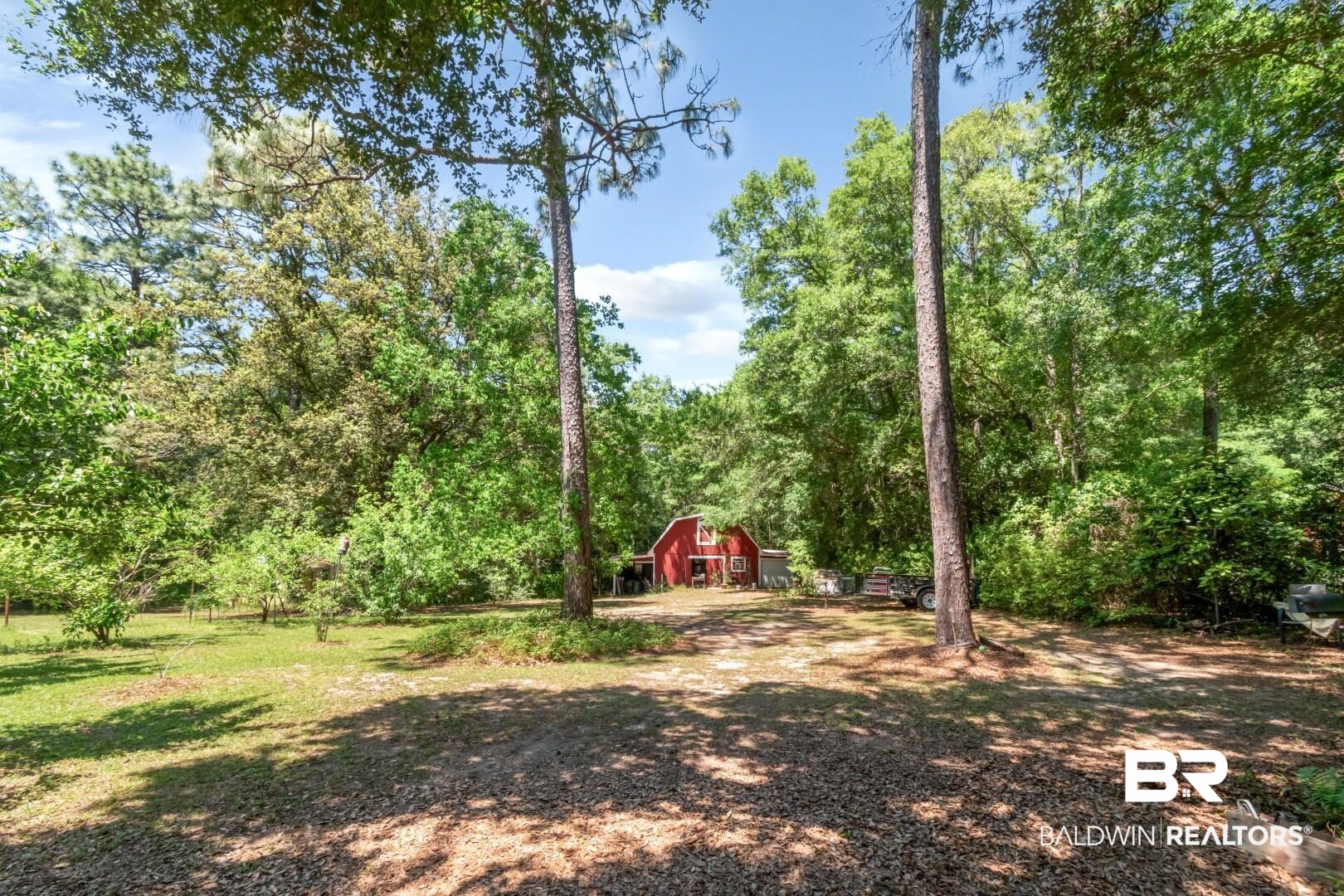 8220 Fordham Road Mobile, AL 36619 - Photo 33 of 41 View of yard with an outdoor structure, a view of trees, and a barn
