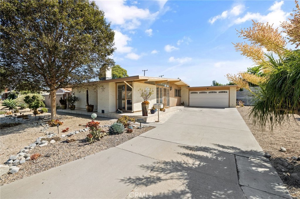 a view of a house with snow on the side of the road